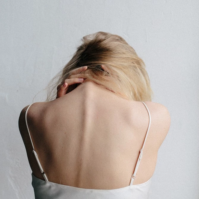 a woman has neck pain